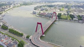 Inscription on video. Rotterdam, Netherlands. Williamsburg Suspension Bridge over the Nieuwe Maas River. Name is burning, Aerial View