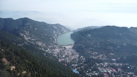 Nainital city lake drone view from Naina peak 8,593 ft with the Himalaya range been seen from the top of the peak.