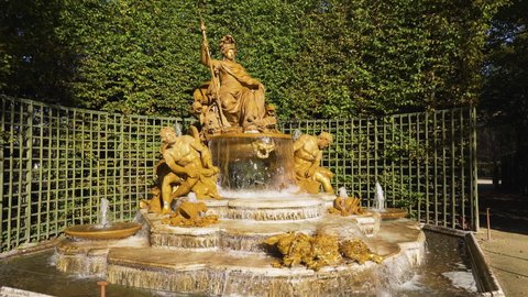 Versailles, France - October 24, 2021: Gardens of the Chateau de Versailles; Triumphal Arch Grove - View of the Fountain of France Victorious.