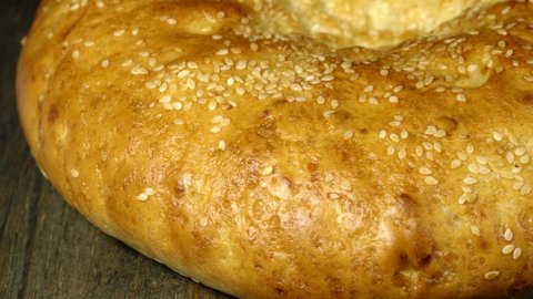 Traditional usbek flatbread with sesame seeds. Close up flatbread. Loop motion