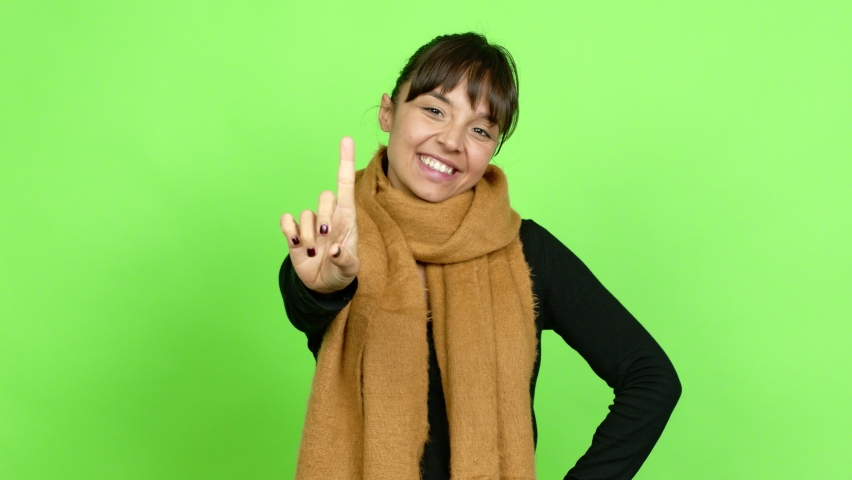 Pretty woman happy and counting with fingers over isolated background. Green screen chroma key Royalty-Free Stock Footage #1085546777
