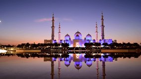 4K timelapse video of the Sheikh Zayed Grand Mosque , the largest mosque in UAE captured during the blue hour from Wahat al Karama, Abu Dhabi.