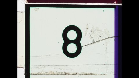 Countdown Leader, Picture Start. 4K Overscan of 16mm Film Showing frame lines and sprocket holes. Black  White Monochromatic Countdown from 8 to 2. Vintage Countdown Clock