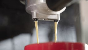 UHD 4k Slow motion B Roll of Pouring coffee stream from machine in cup. Home making hot Espresso. Using filter holder. Flowing fresh ground coffee. Drinking roasted black coffee in the morning. 
