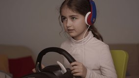 Girl Playing Racing Video Game in Game Console. Child Playing Computer Game in Headphones With Steering Wheel. Gamer With Headset Holding Steering Wheel Playing Video Game. Kid Gambling Addiction.