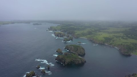 Beautiful Unnamed Bay, in Shikotan Island. Drone Flying in a Clouds Lesser Kuril Chain, Coastline of Pacific Ocean, Russia.
