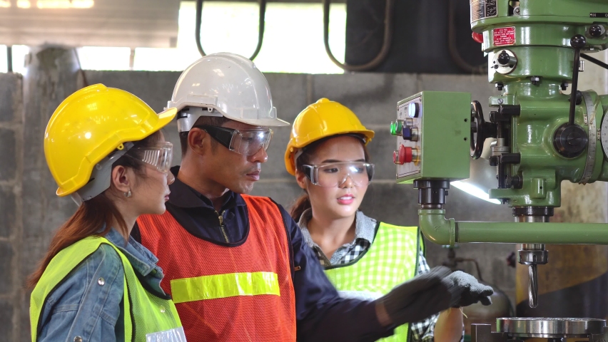 Asian male foreman manager showing case study of factory machine to two engineer trainee young woman in protective uniform. teamwork people training and working in industrial manufacturing business Royalty-Free Stock Footage #1085570930