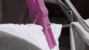 Plastic pink clothesline peg extreme slow motion close up stock footage