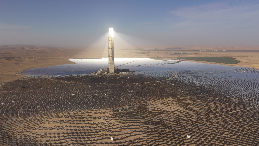 Aerial view of massive solar power tower absorbing sunlight from moving mirrors at Ashalim power station in Israel. Global warming and sustainable energy production. Royalty-Free Stock Footage #1085579990