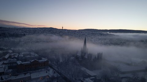 Panorama Of Nidaros Cathedral Covered With Light Fog In Trondheim, Norway. aerial