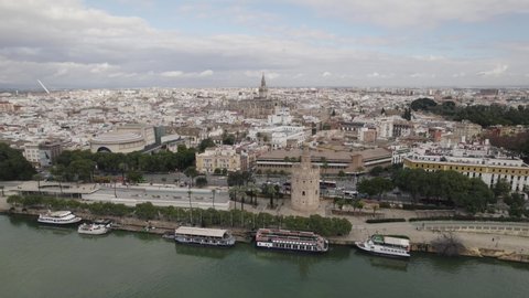 Aerial from Torre del Oro (military watchtower) towards Seville Cathedral, stunning cityscape.
