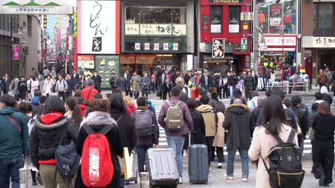 Tokyo, Japan - 3 April 2019 : crowd people walking cross road in front of Ameyayokocho a famous walking street near Ueno train station