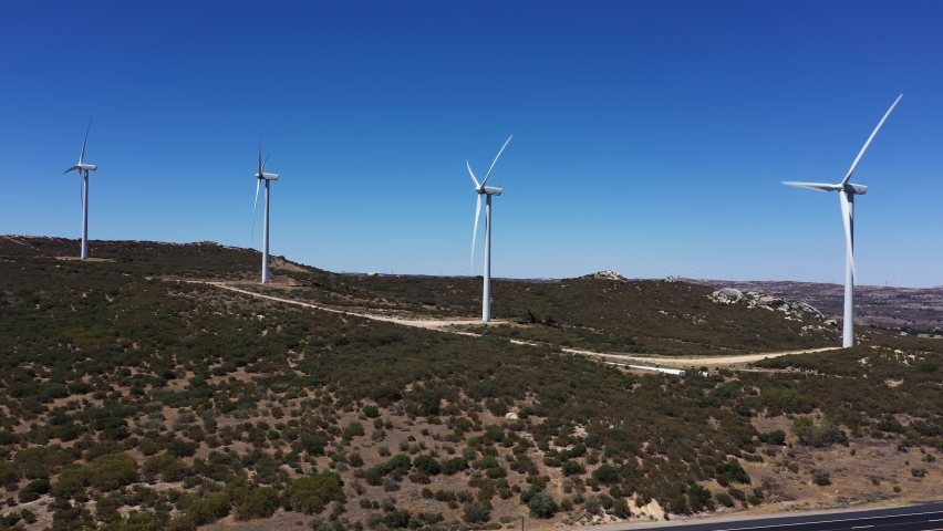 Large wind turbines alternative clean energy California drone orbit.