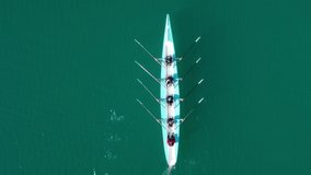 Aerial drone bird's eye view video of two sport canoe operated by team of young men and women 
