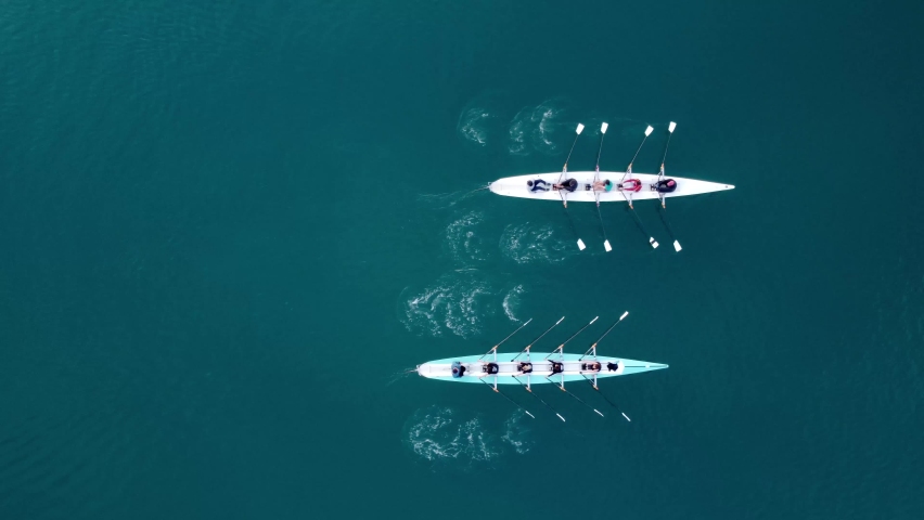 Aerial drone bird's eye view video of two sport canoe operated by team of young men and women  | Shutterstock HD Video #1085609027