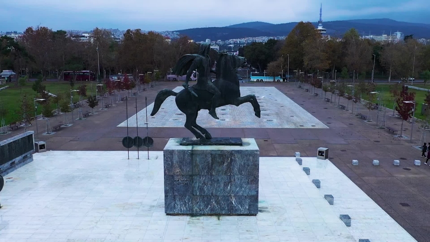 Monument to Alexander the Great on the embankment in the city of Thessaloniki in Greece on the shores of the Thermaikos Gulf of the Aegean Sea against the backdrop of Mount Olympus. Drone shooting. 