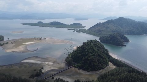 4K in aerial view over Laem Son National Park with wave beach and 
lot of pine trees in the park's beach area. Laem Son National park is locate in Kapur District, Ranong, Thailand