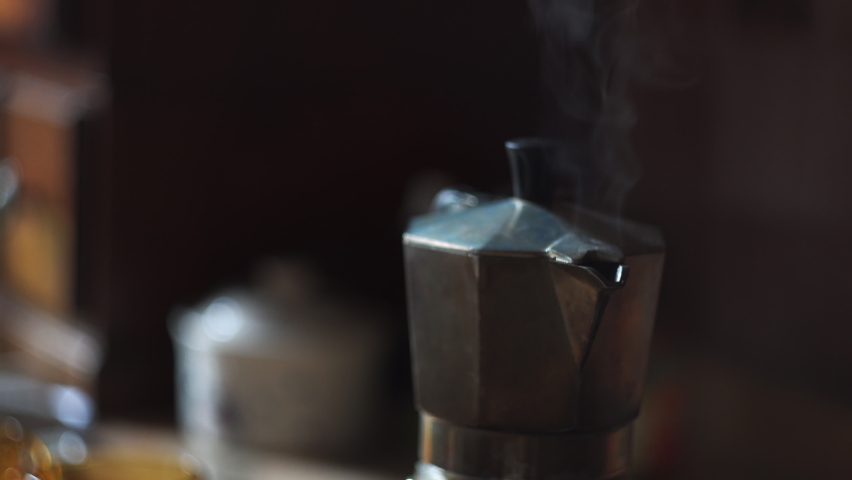 smoke coming out from a moka because the coffee is ready and hot