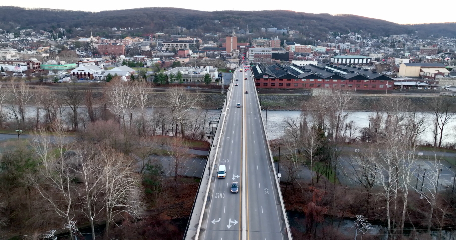Bridge over Lehigh River in Bethlehem Pennsylvania during winter. Slow motion clip of traffic driving. Aerial.