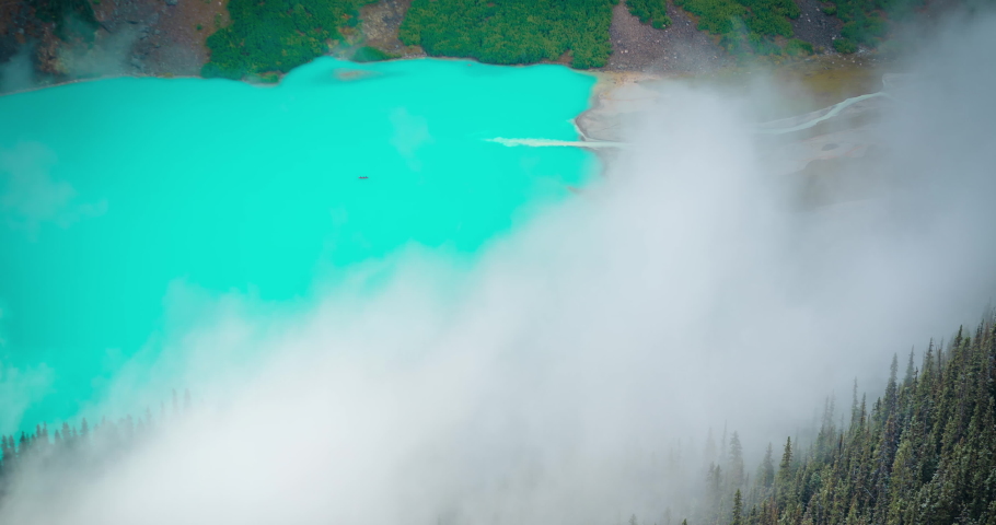 Time lapse, moving fog above aqua blue glacial water in high elevation, Lake Louise Banff National Park, Canada