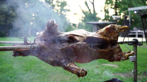 ram sheep roasted on the rotisserie barbecue. Rustic traditional ram barbecue.