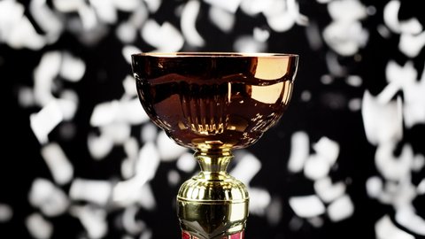 Golden cup on black background close-up. Having first place. Award and victory, winning the championship, success. 