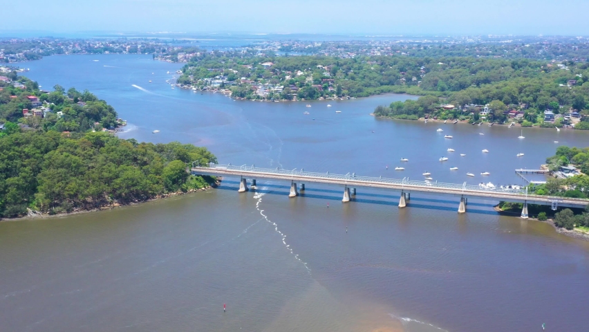 Aerial drone dolly view of Como Bridge on the Georges River in southern Sydney, Australia looking east to Coronation Bay during summer on a sunny day 