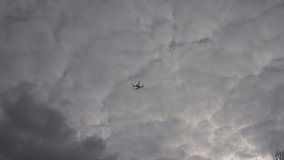 A drone hanging still in the sky in a cloudy day.