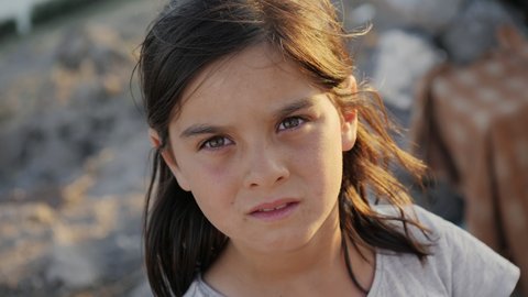 Cappadocia, Turkey, summer 2021: close-up of a little girl from poor villages and slums looking at the camera with interest and hope
