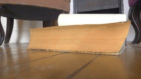Old book falling to the floor in slow motion 180fps - Powered by Shutterstock - Get 15% off with code: PIKWIZARD15