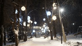 City boulevard decorated with New Year and Christmas illumination, snowfall - Powered by Shutterstock - Get 15% off with code: PIKWIZARD15