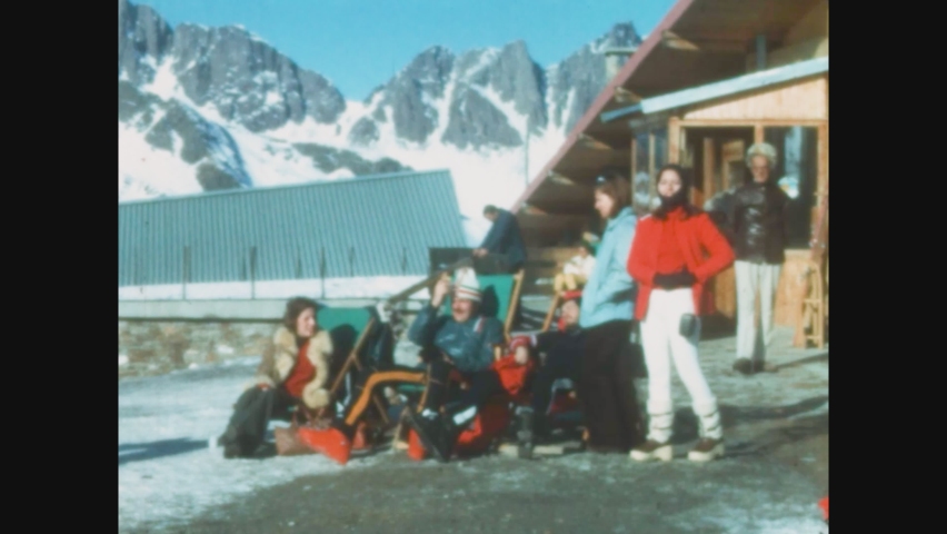 DOLOMITES, ITALY JANUARY 1970: People relax in outdoor ski resort in 70's
