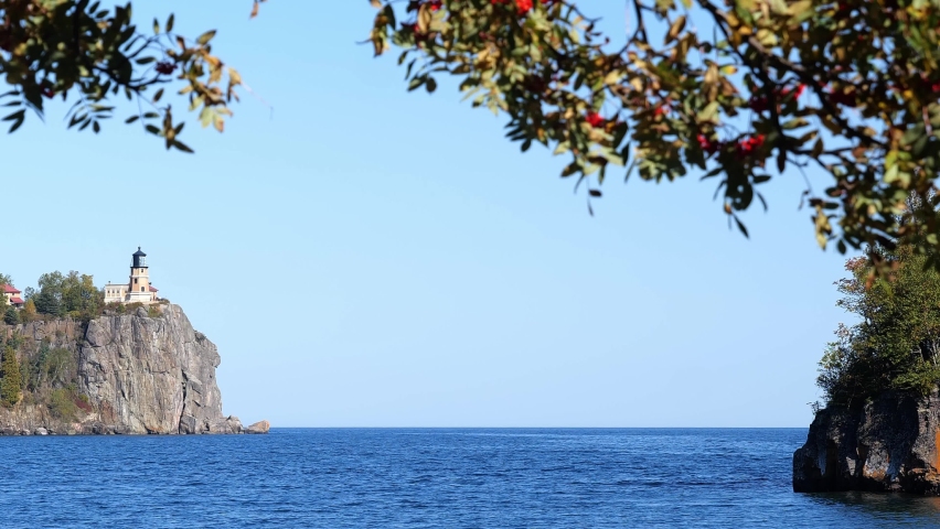 Focus shift from the Split Rock Ligthhouse to the near Mountain Ash branches on the north shore of Lake Superior in Minnesota, a popular travel destination for tourists on the great lake.