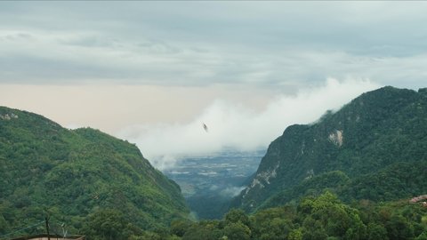 Time lapse view landscape of Doi Pha Hi an intricate mountain range in Mae Sai district of Chiang Rai province of Thailand in rainy season