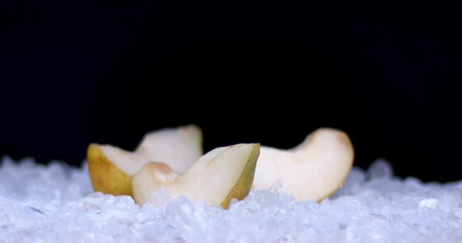 Slow motion of ice cubs filling in sliced pears, fresh fruits for juicy, cold, white food for summer time. Filmed on high speed cinema camera, 8K downscale, 4K.