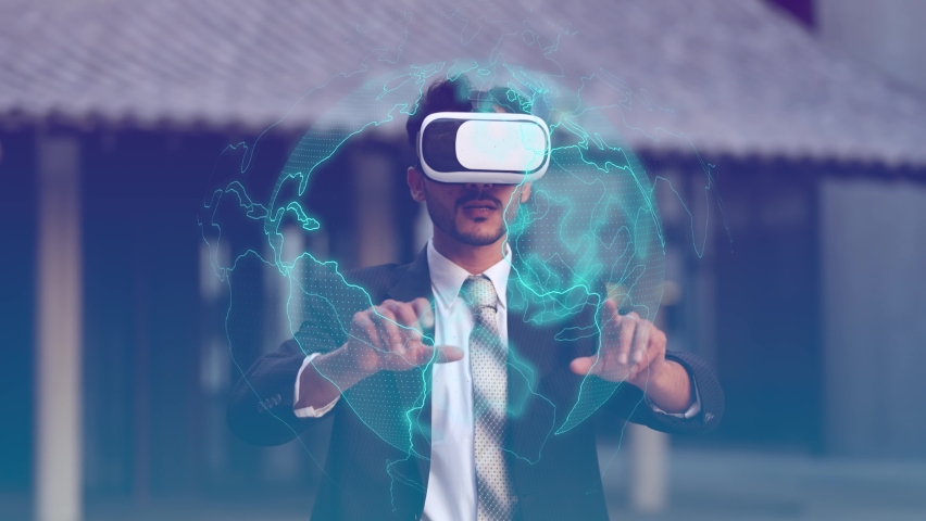 Asian Businessman wearing and using VR virtual reality goggle and experiences of metaverse virtual world for business future. man using hand to move and rotate sphere icon with showing imagination. | Shutterstock HD Video #1085637509