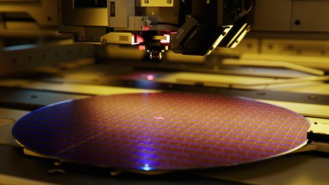 Shot of Silicon Wafer being processed at Semiconductor Foundry, that produces Computer Chips.