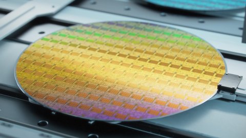 Beauty Shot of Colorful Silicon Wafer at Advanced Semiconductor Foundry, that produces Computer Chips.