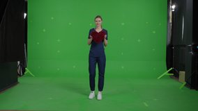 Young professional doctor wear uniform with stethoscope on the camera over green screen background. Smiling foreman woman holding paper heart shape . Valentine's day Chroma Key 4k video footage