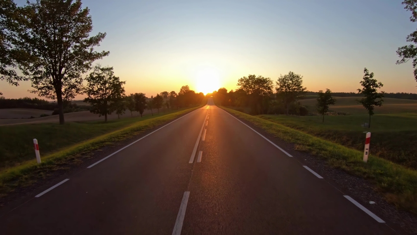 On a rural road to sunset, pov