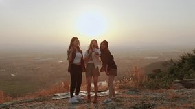 girl friend group Asians blogger standing and caper enjoying the beauty of nature in the evening sunset and shoot video from their action cams to show off to their friends in social media,freedom conc