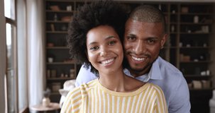 Headshot portrait happy millennial Black husband wife posing at home smiling looking at camera. Satisfied young married family couple get loan mortgage leave positive video feedback enjoy good service