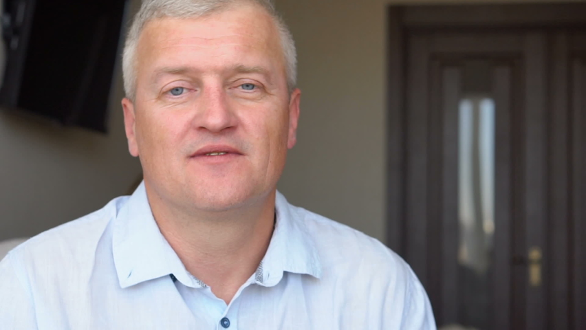 Family portrait of mature father and little blonde daughter hugging at home while celebrating father
