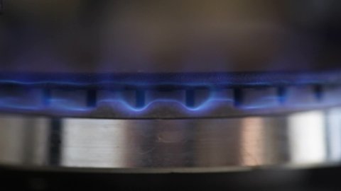 natural gas inflammation in stove burner close up view 