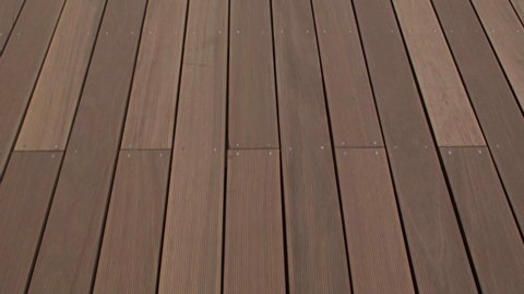 Movement along a path of wooden boards. Close up. The floor of the terrace is made of natural materials resistant to weather influences.
