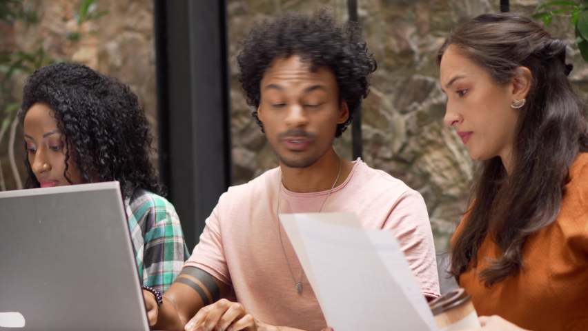 Excited black man explains business plan to female colleagues with laptop. Casual university students meet to study.
 Royalty-Free Stock Footage #1085650259