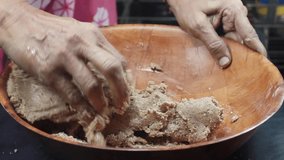 Indian lady kneading dough for Roti,bhakhri[Indian flat bread]
