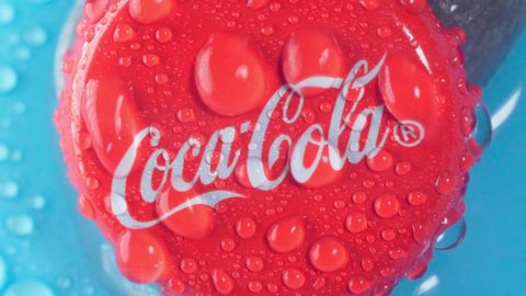 Tyumen, Russia-January 19, 2022: Coca Cola cap logo close up with water drops. Selective focus. Slow motion