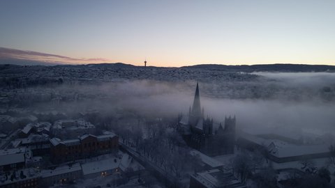 Nidaros Cathedral Shrouded In Mist During Winter In Trondheim, Norway - aerial drone shot