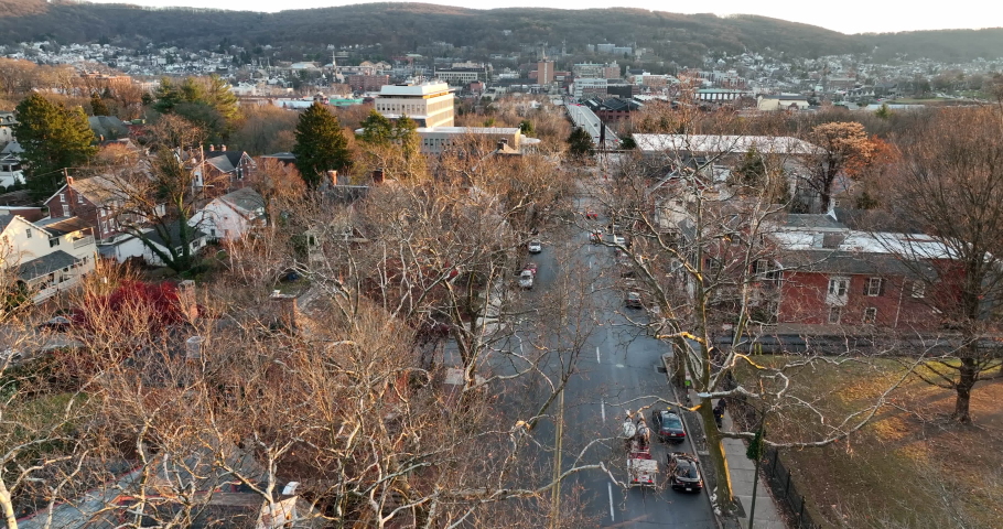 Lehigh County Pennsylvania in winter light. Aerial of Bethlehem PA. Horse and carriage visible through trees. Christmas holiday season.